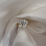 18ct Yellow Gold trilogy Ring featuring Emerald Cut Diamond and two side stones 