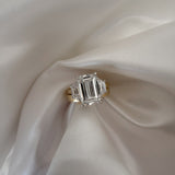 18ct Yellow Gold trilogy Ring featuring Emerald Cut Diamond and two side stones 