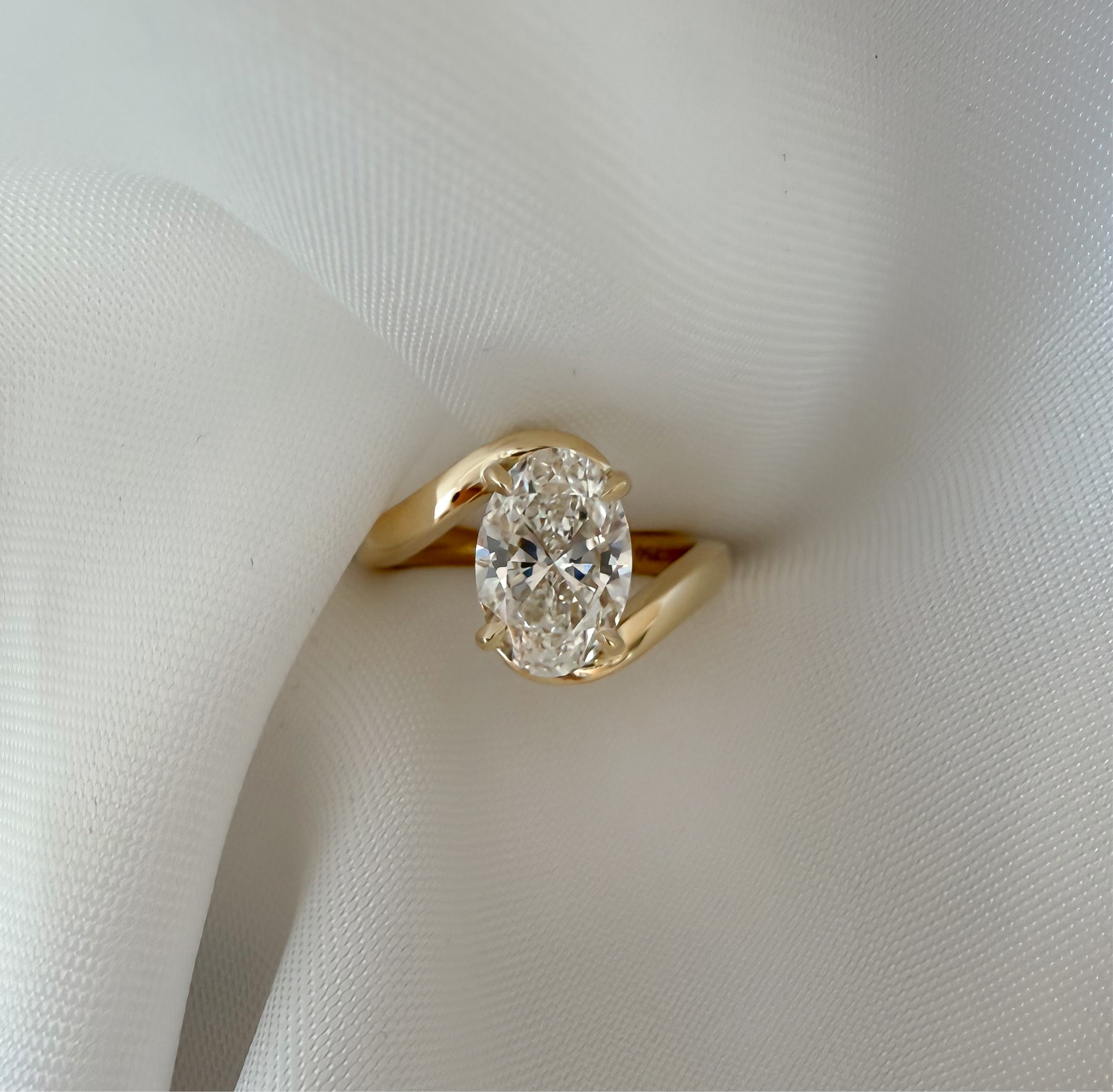bespoke oval diamond engagement ring in 18ct yellow gold, handcrafted by Casoni Fine Jewellery in Sydney.