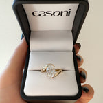 18ct Yellow Gold ring in a Casoni box held by a hand