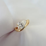 Gold engagement ring with pear diamond set diagonally 